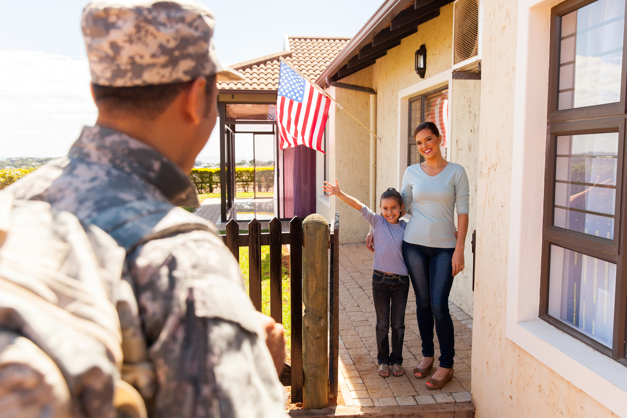 excited young american family welcoming military father returning home